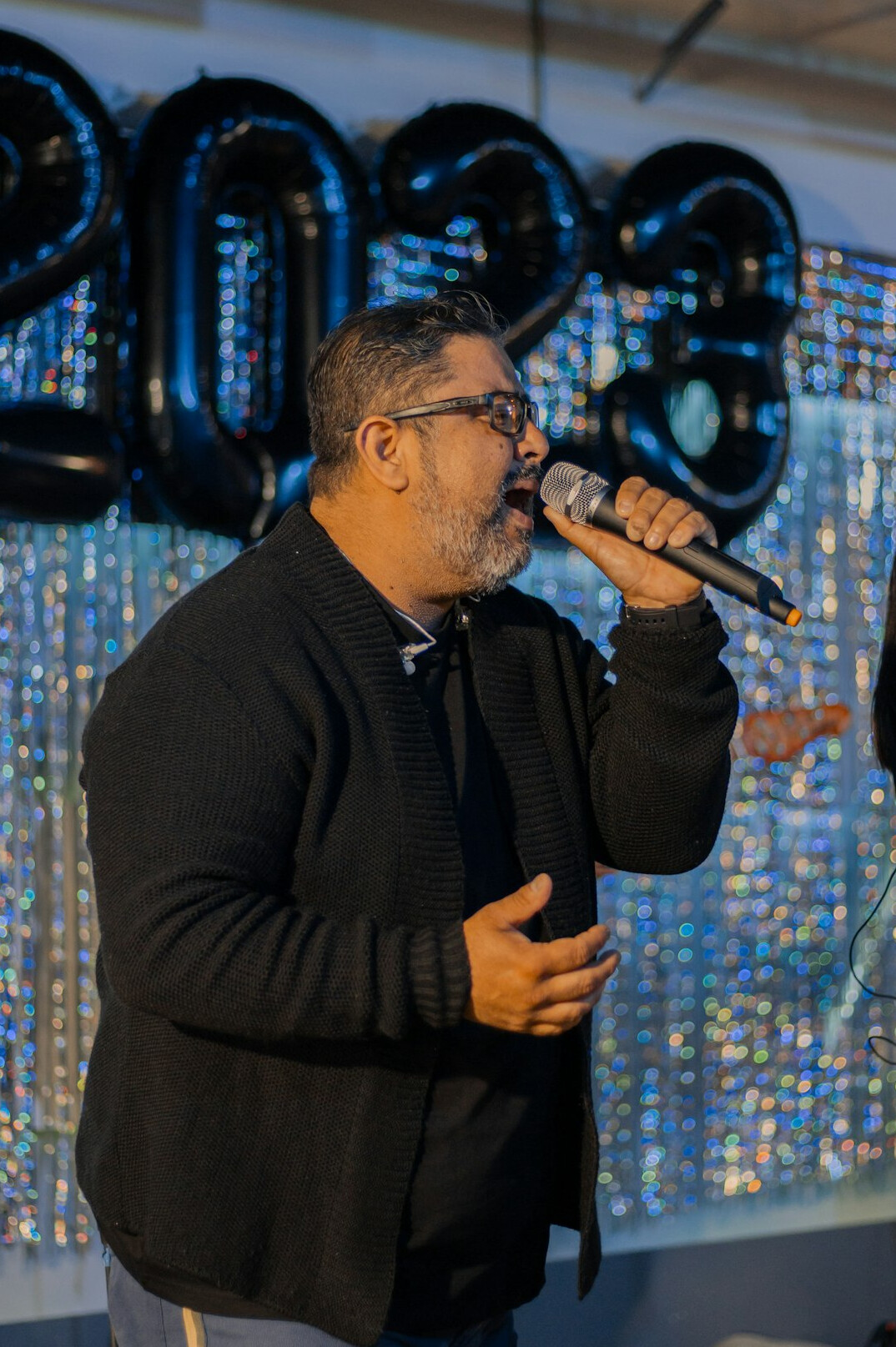 Man speaking with a microphone in front of an audience